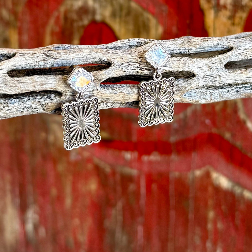 Women’s Montana Silversmiths silver post canyon earrings in silver, square cubic zirconia post for subtle sparkle, with engraved Western scroll drop for classic style – ER6451. Available at Blair's Western Wear, Marble Falls, TX.