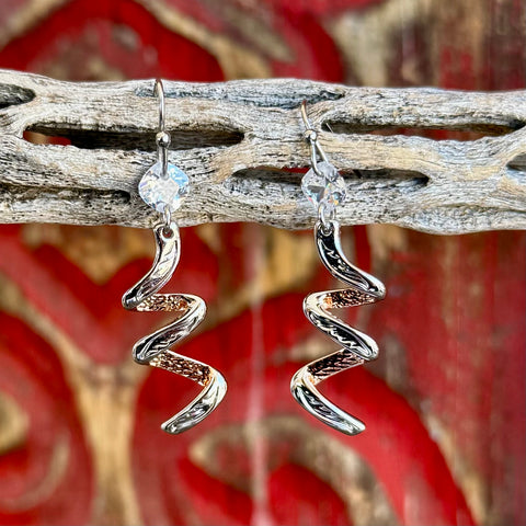 Women’s Montana Silversmiths earrings swirl bling earrings in silver, fluid swirl drop design that catches light with movement, with clear crystal accent and two-tone metal detailing - ER6463. Available at Blair's Western Wear, Marble Falls, TX.