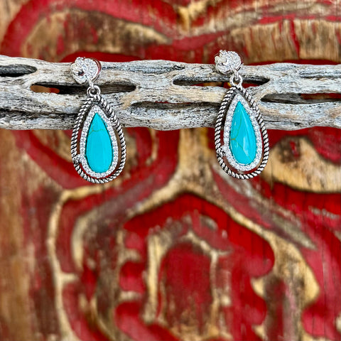 Women’s Montana Silversmiths earrings turquoise teardrop stone dangle earrings in silver, featuring a lightweight feel for all-day comfort, with a detailed rope border for added Western style – ER5858. Available at Blair's Western Wear, Marble Falls, TX.