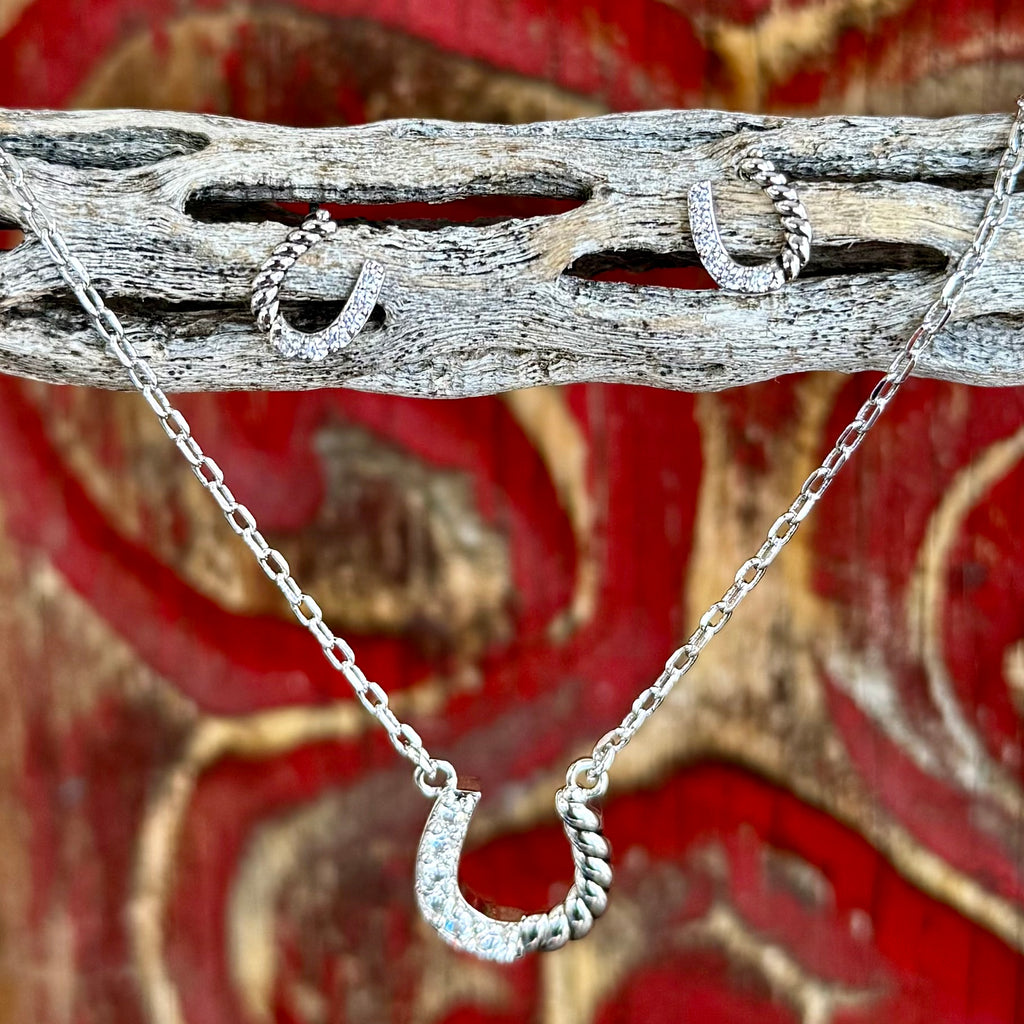 Women’s Montana Silversmiths jewelry set silver horseshoe necklace and earrings in silver, featuring clear handset stones, with twisted-rope detailing – JS5969. Available at Blair's Western Wear, Marble Falls, TX.