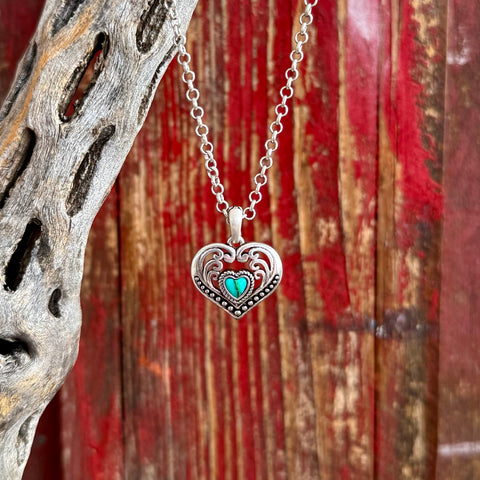 Women’s Montana Silversmiths silver heart pendant necklace in silver with turquoise-colored center stone, featuring detailed Western scrollwork and beaded border accents - NC6103. Available at Blair's Western Wear, Marble Falls, TX.