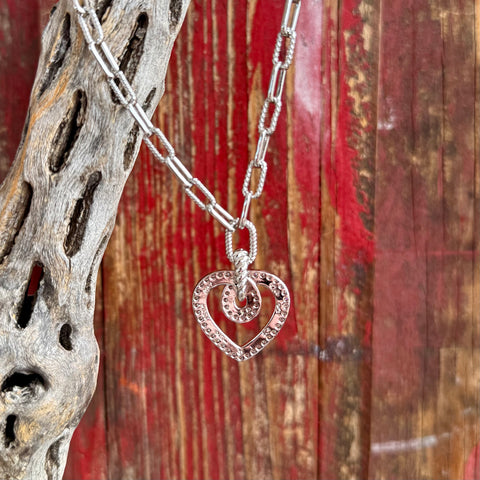 Women’s Montana Silversmiths necklace silver heart pendant in silver, clear cubic zirconia stones line the open heart frame for added sparkle, with a linked chain featuring smooth and textured oval links - NC6472. Available at Blair's Western Wear, Marble Falls, TX.