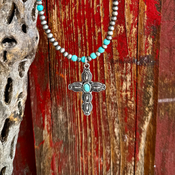 Women’s Montana Silversmiths necklace stone cross in silver and turquoise, engraved cross pendant with turquoise center stone, with silver and turquoise beaded necklace – ANC5420. Available at Blair's Western Wear, Marble Falls, TX.