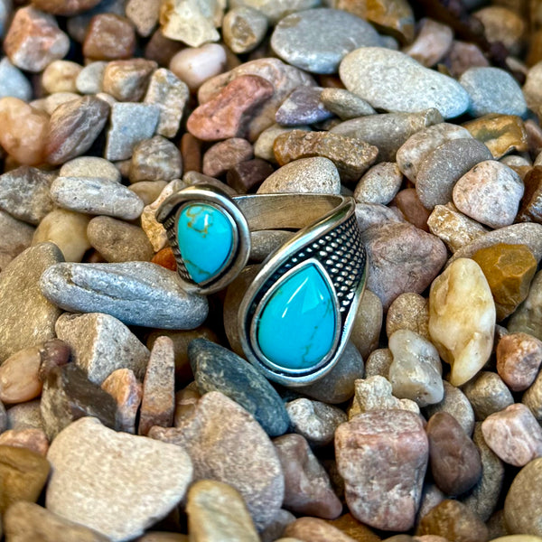 Women’s Montana Silversmiths ring turquoise wrap ring in silver-tone, adjustable wrap design for comfortable fit, with dual pear-shaped turquoise stones and textured band detail – RG5968. Available at Blair's Western Wear, Marble Falls, TX.