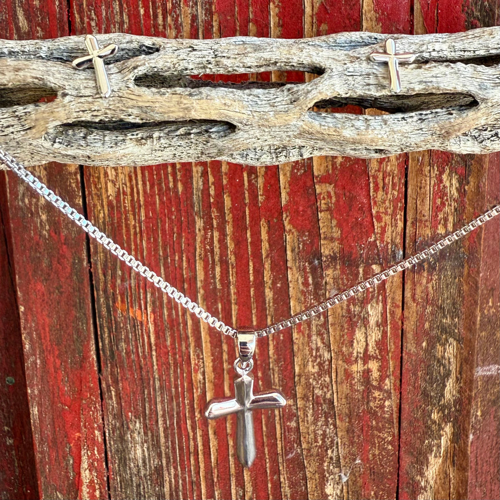 Women’s Montana Silversmiths jewelry set with silver cross pendant and matching earrings, featuring a raised polished design and hypoallergenic posts – JS5950. Available at Blair’s Western Wear, Marble Falls, TX.