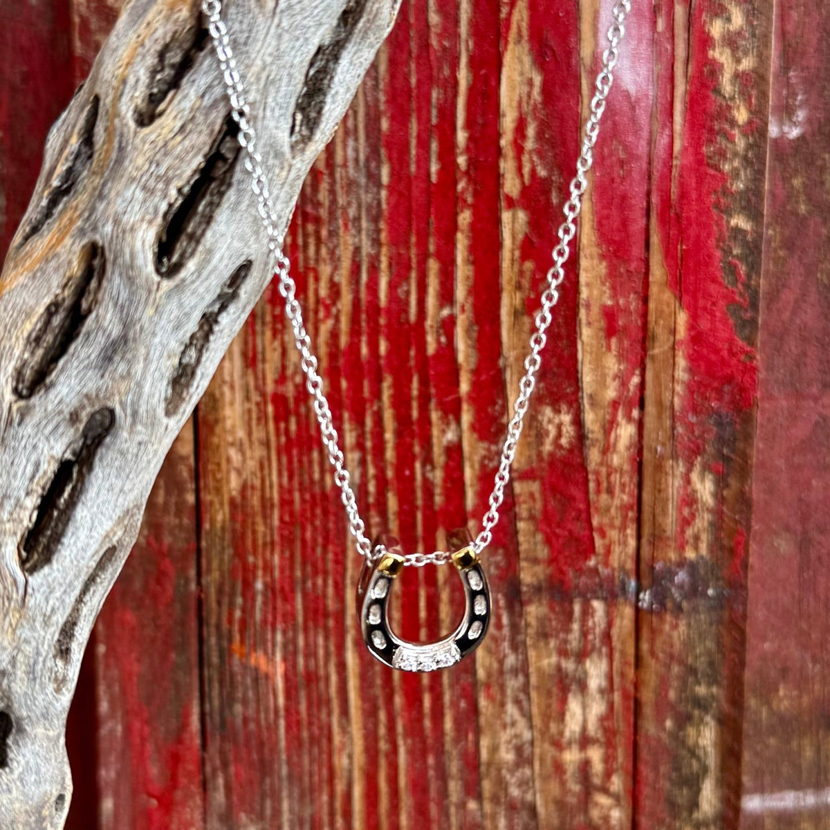 Women's Montana Silversmiths silver necklace in horseshoe pendant style, silver-tone finish with contrasting black inlay enhances depth and detail, with clear cubic zirconia stones set along the horseshoe for added sparkle - QNC6429. Available at Blair's Western Wear, Marble Falls, TX.