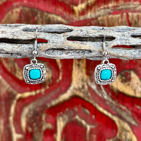 Women’s Montana Silversmiths silver dangle stone earrings with turquoise center, antiqued silver frame, and lightweight drop design – ER1263. Available at Blair's Western Wear, Marble Falls, TX.