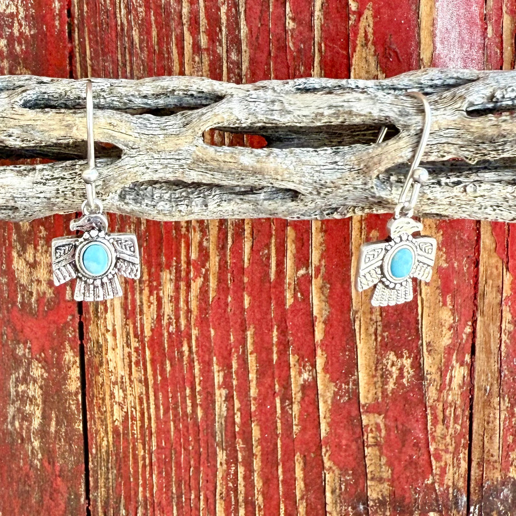 Women’s Montana Silversmiths turquoise thunderbird dangle earrings in silver, crafted with detailed engraving, featuring a central turquoise stone for color contrast, and finished with tarnish-resistant Montana Armor – ER6315. Available at Blair’s Western Wear, Marble Falls, TX.