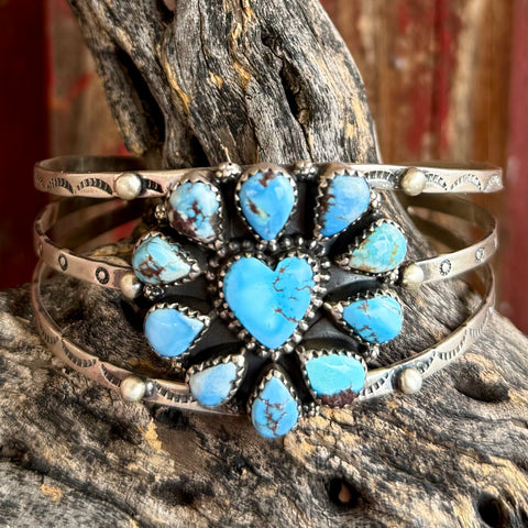 Women's Nizhoni Traders Bracelet Cuff in Light Blue, genuine Golden Hills turquoise cluster with heart-shaped center stone, with handcrafted sterling silver triple-band cuff and stamped detailing - NZBRHRTBLU. Available at Blair's Western Wear, Marble Falls, TX.