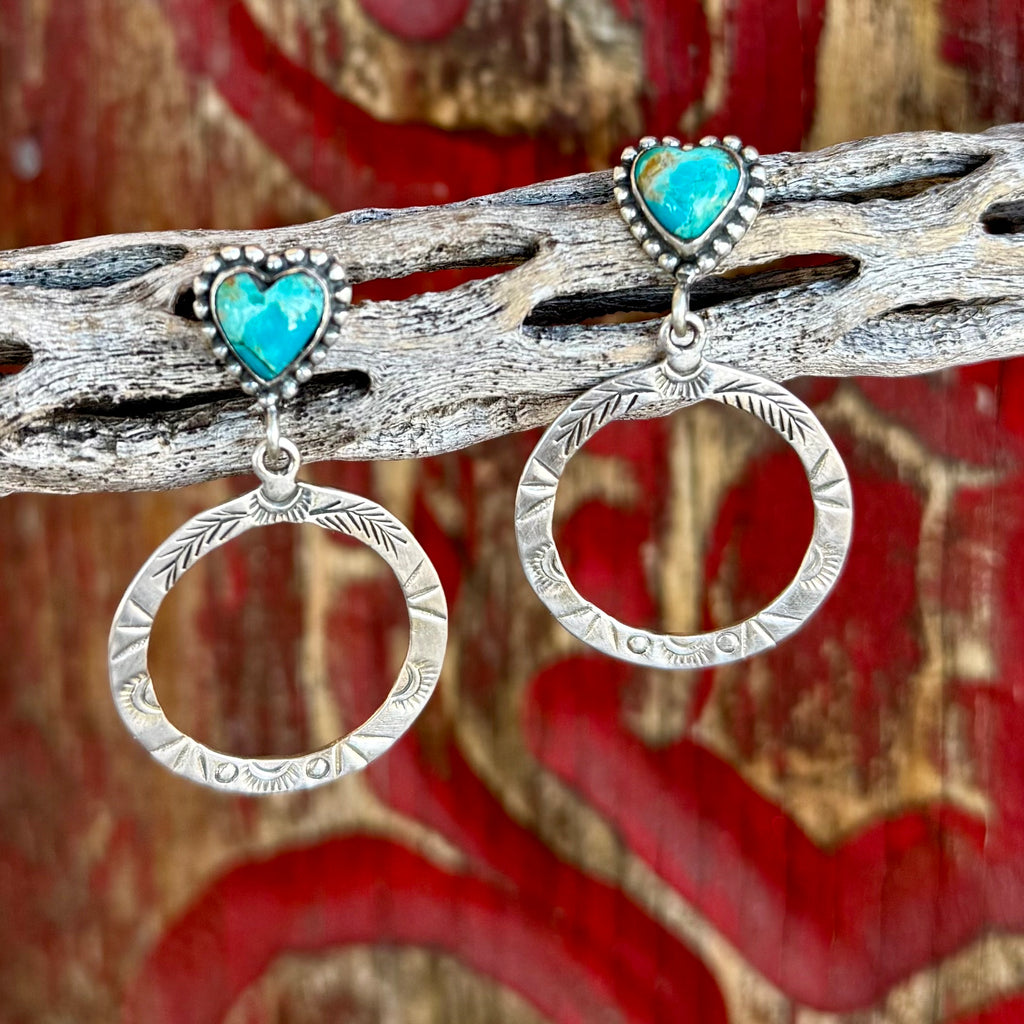 Women's Nizhoni Traders earrings heart post circle drop in silver and turquoise, genuine turquoise heart-shaped stones with sterling silver stamped circular drop design - NZERHRTCR. Available at Blair's Western Wear, Marble Falls, TX.