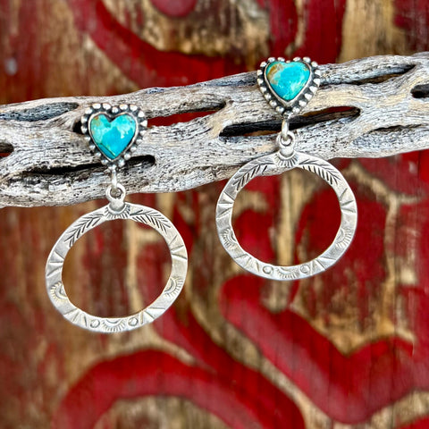 Women's Nizhoni Traders earrings heart post circle drop in silver and turquoise, genuine turquoise heart-shaped stones with sterling silver stamped circular drop design - NZERHRTCR. Available at Blair's Western Wear, Marble Falls, TX.