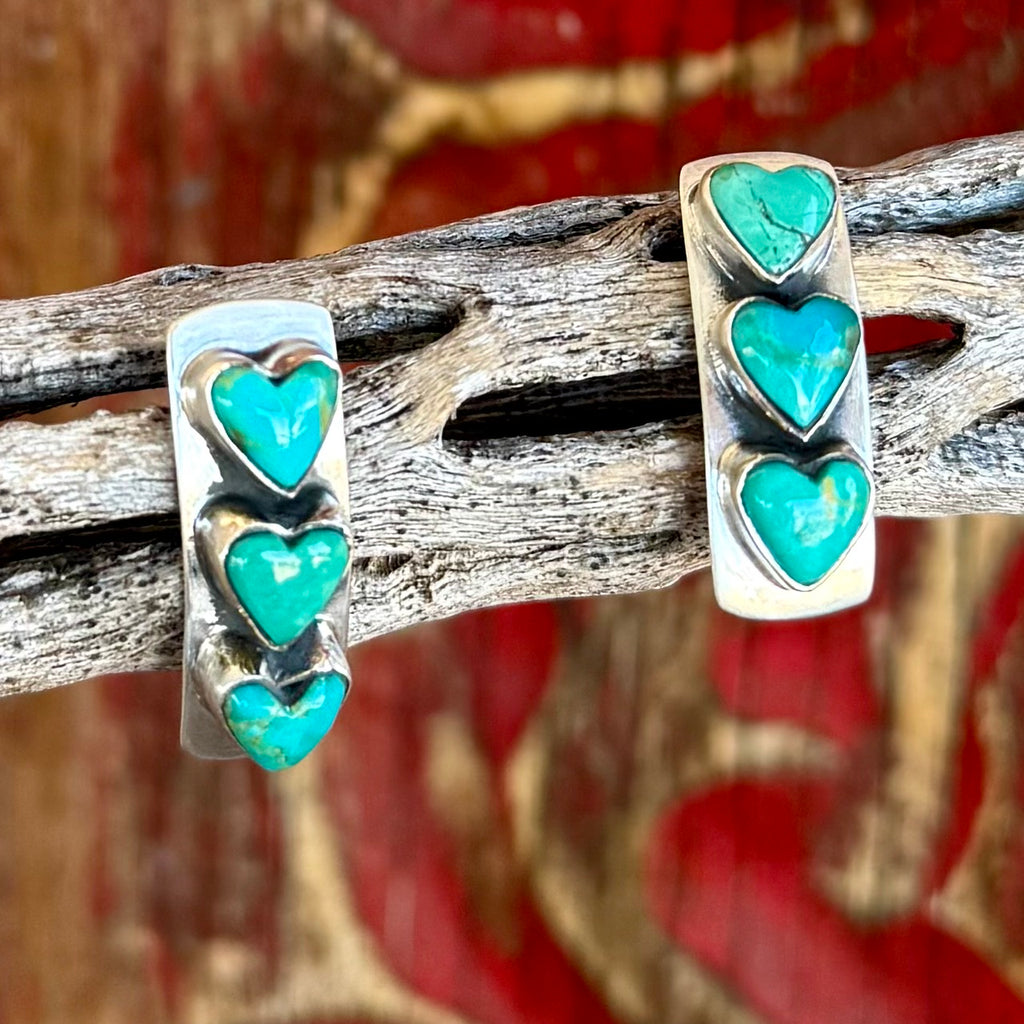 Women's Nizhoni Traders Earrings Turquoise Heart Post Earrings in Turquoise, three genuine turquoise heart stones create a bold vertical design, with hand-set stones in sterling silver bezels that highlight natural matrix - NZER3HRT. Available at Blair's Western Wear, Marble Falls, TX.