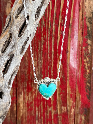 Women's Nizhoni Traders Turquoise Sterling Silver Heart Necklace in Turquoise, genuine Kingman turquoise heart stone provides vibrant natural color, with handcrafted sterling silver rope-edge bezel setting - NZNKHEART. Available at Blair's Western Wear, Marble Falls, TX.