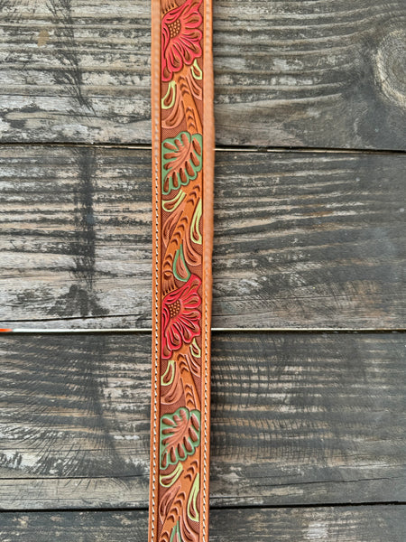 Natural tan tooled leather with hand-painted coral flowers and sage green leaves — a beautifully crafted western belt with cream stitched edges. Available at Blair's Western Wear located in Marble Falls, TX.