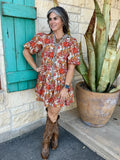 72670 — Women's retro floral puff sleeve tiered mini dress with bold red, pink, burnt orange, and golden floral print on caramel base, leopard contrast trim along spread collar and center front placket, short puff sleeves, and drop-waist tiered ruffle skirt — Blair's Western Wear Marble Falls TX