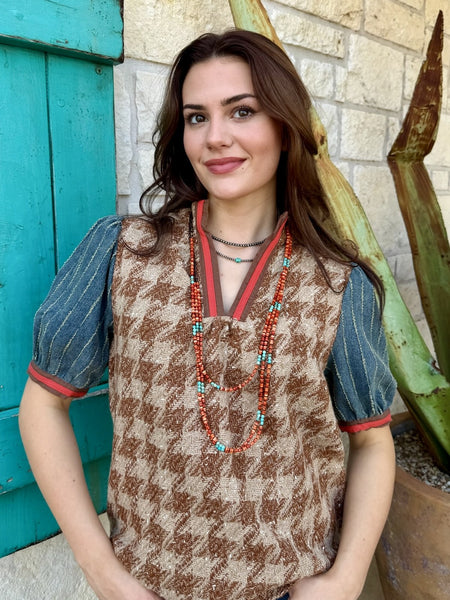 Close-up of denim puff sleeve with distressed stripe detail and red trim cuff on brown herringbone tweed top — Blair's Western Wear Marble Falls TX