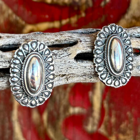 Women's Silver Western Concho Post Earrings in Silver, polished oval center that reflects light, with classic teardrop concho-style stamping for Southwestern character - T1546. Available at Blair's Western Wear, Marble Falls, TX.