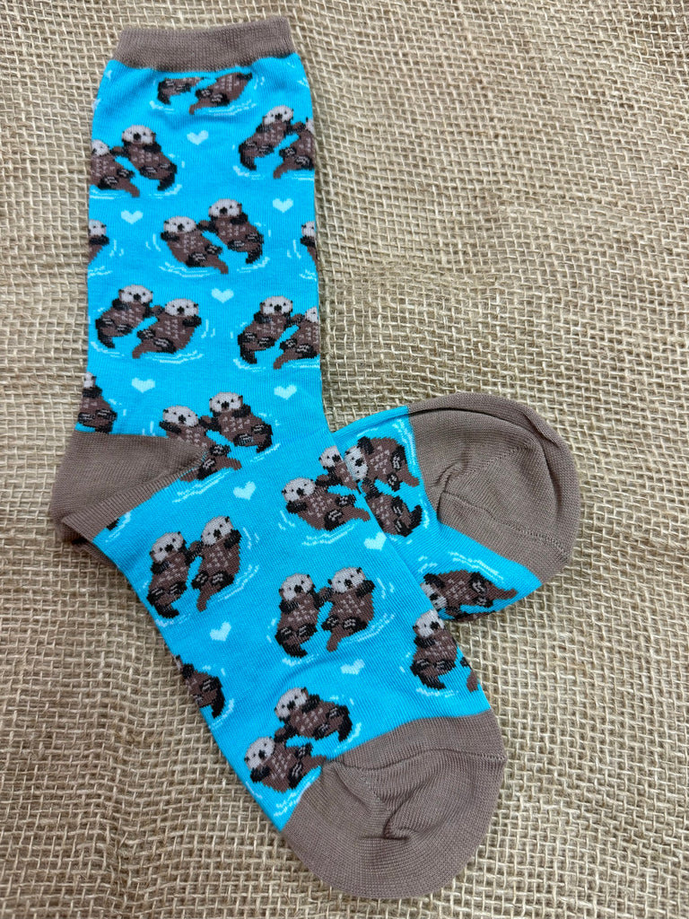 Women’s Socksmith Significant Otter novelty crew socks in bright blue, featuring playful otter and heart design, with soft cotton blend comfort and reinforced brown heel and toe - WNC581. Available at Blair's Western Wear, Marble Falls, TX.