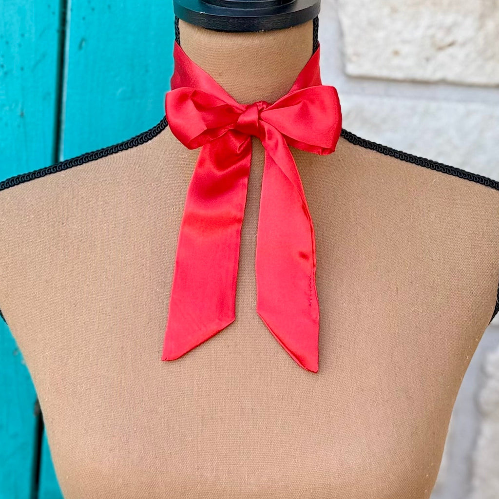A bright red satin neck scarf 