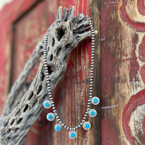 Women's Sunwest Silver Necklace Heart Dot Neck Chain in Silver/Turquoise, crafted from heavy-gauge sterling silver for durability, with genuine turquoise stones in rope bezel settings for a bold, handcrafted look - SUNNKDROPP. Available at Blair's Western Wear, Marble Falls, TX.