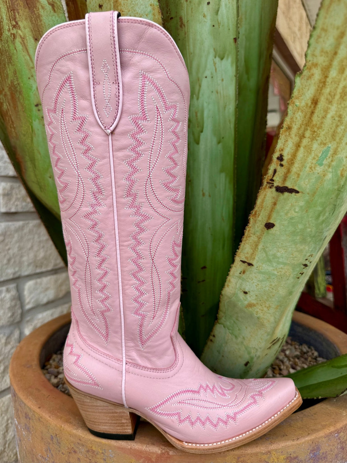 Pink boot with intricate stitching 