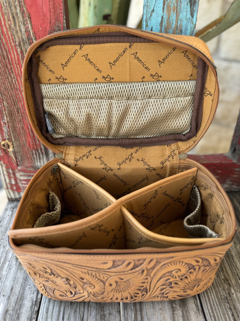 ADBG1251G — This gorgeous tan leather train case is covered in full-coverage deep hand-carved sunflower and feather scroll tooling with dark brown antiqued contrast, a smooth tan leather top lid, zip-around tan zipper, and reinforced tan leather carry handle with dark hardware — pure western artisan style — Blair's Western Wear Marble Falls TX
