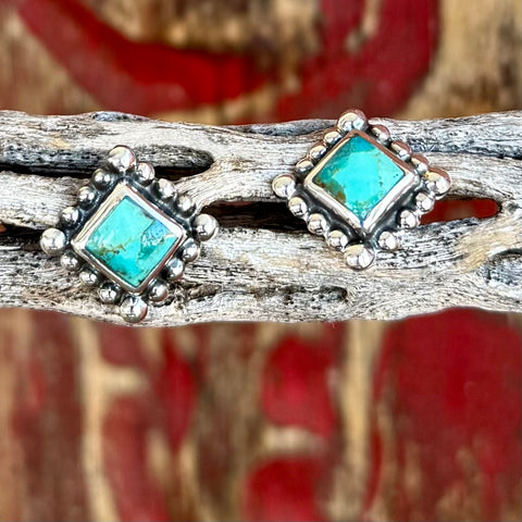 Women's turquoise square post earrings in silver, genuine turquoise stone set in a square silhouette with natural veining, with beaded dot border detailing - T1520. Available at Blair's Western Wear, Marble Falls, TX.