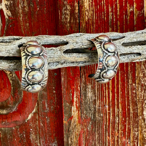 Womens Boho Oval Semi-Hoop Silver Earrings with raised concho detailing and smooth, comfortable inner edges – T1504X. Available at Blair's Western Wear, Marble Falls, TX.