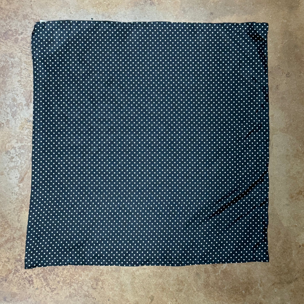 Wyoming Traders silk wildrag scarf in black with white polka dots, crafted from 8 mm silk, with hand-rolled hem for durability – SCB. Available at Blair's Western Wear, Marble Falls, TX.