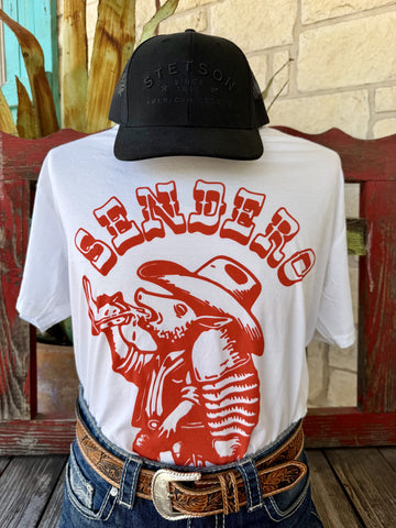 Men's white Sendero Provisions Co. Armadillo Drinkin' short sleeve tee with bold red cowboy armadillo cigar back graphic and SENDERO arch lettering, back view styled with jeans and tooled leather belt — Blair's Western Wear Marble Falls TX

