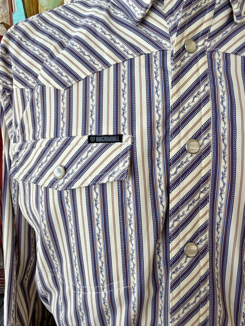 Close-up of natural and blue vine-striped shirt showing diagonal-striped yoke, placket and pocket flap with pearl-style snaps — Blair's Western Wear Marble Falls TX