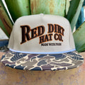 Men's tan mesh trucker cap with embroidered Red Dirt Hat Co. logo and camo bill with orange accents — Blair's Western Wear Marble Falls TX