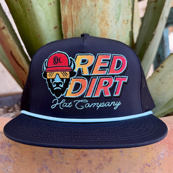 Men's black Red Dirt Hat Co. Cool Buffalo mesh trucker cap with bold embroidered buffalo mascot in red cap and sunglasses and RED DIRT Hat Company yellow orange gradient block letters with turquoise rope brim accent, front view — Blair's Western Wear Marble Falls TX