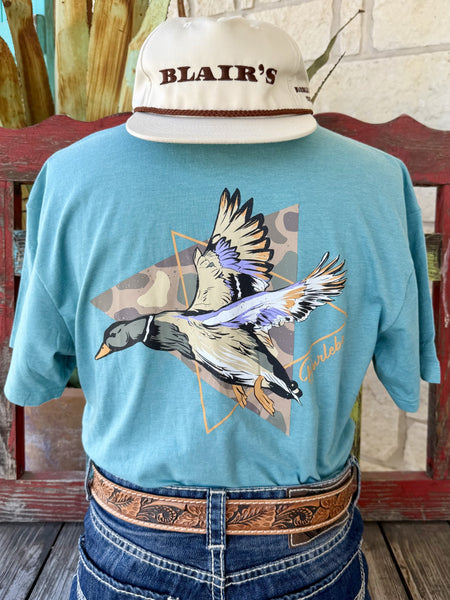 Men's aqua teal Burlebo Duck Triangle Camo short sleeve tee with bold mallard duck in flight over tan olive diamond camo background with gold triangle frame and Burlebo gold script, back view styled with jeans and tooled leather belt — Blair's Western Wear Marble Falls TX