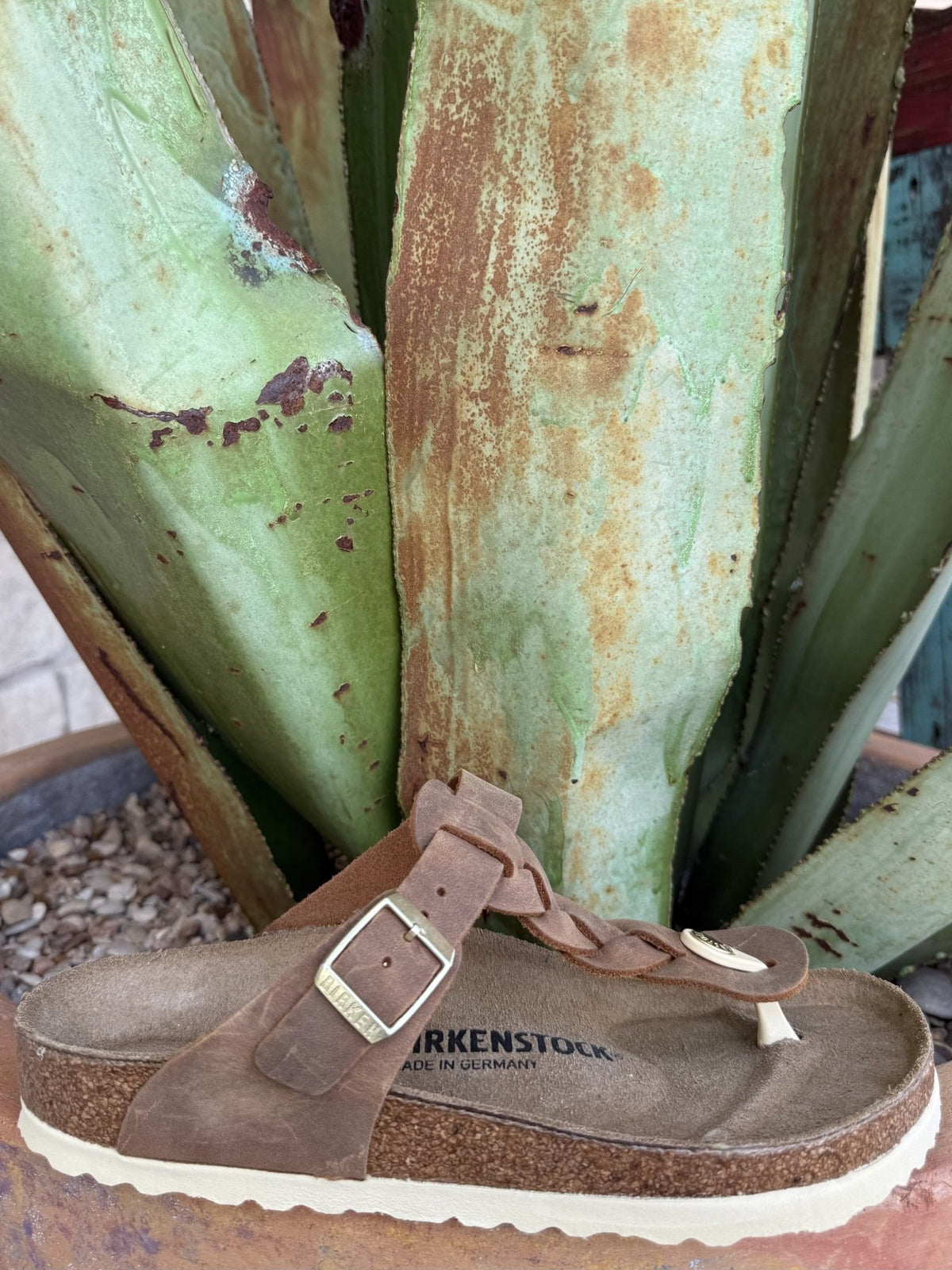 Women's cognac oiled leather thong sandal with a braided strap, adjustable buckle, and cork footbed — Blair's Western Wear Marble Falls TX⠋