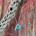 Women's Boho Sol Necklace Bubble Letter Pendant in Turquoise, handcrafted with vibrant turquoise cabochons, with a durable sterling silver base - T320. Available at Blair's Western Wear, Marble Falls, TX.