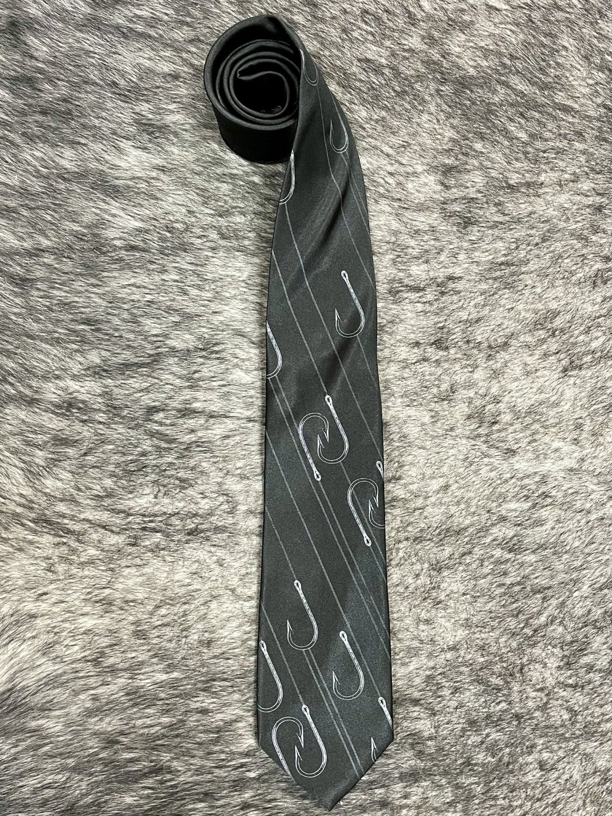 Men's black necktie with silver fish hook and fishing line novelty print, smooth woven finish, standard width pointed tip — Blair's Western Wear Marble Falls TX