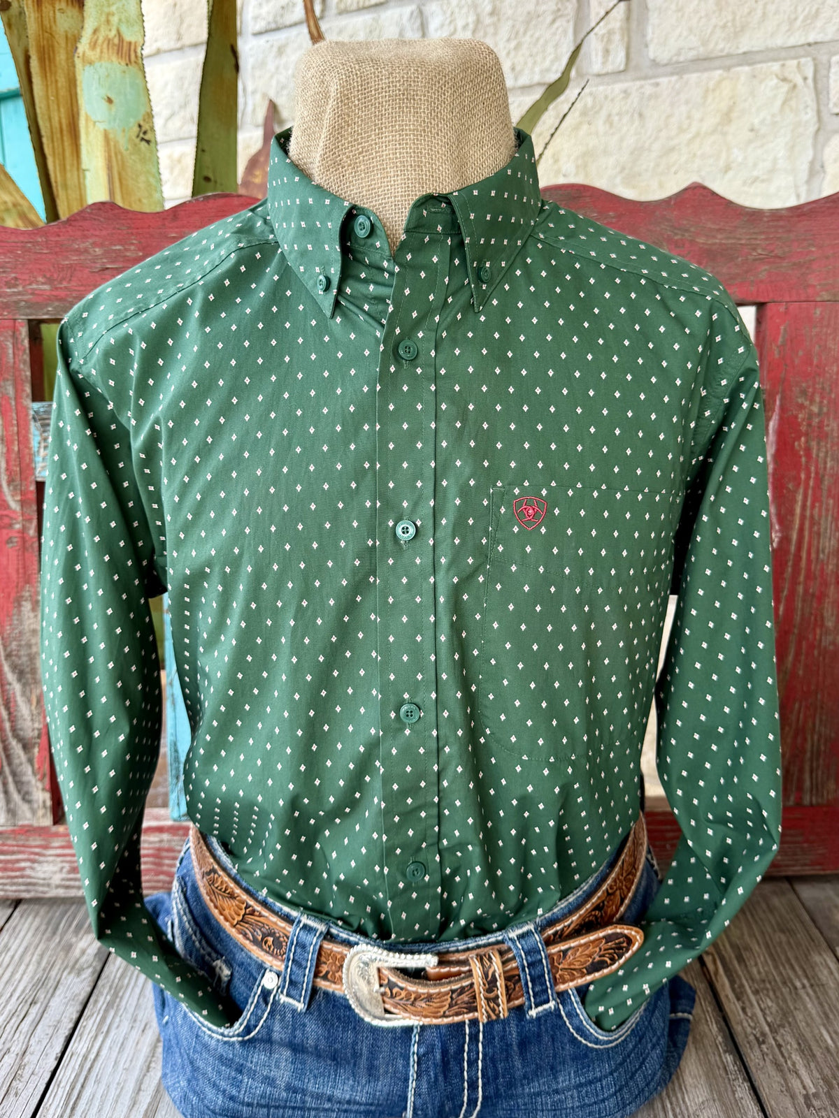 Men's hunter green long sleeve shirt with small white and pink diamond print, button-down collar, green buttons, and chest pocket with pink embroidered logo — Blair's Western Wear Marble Falls TX