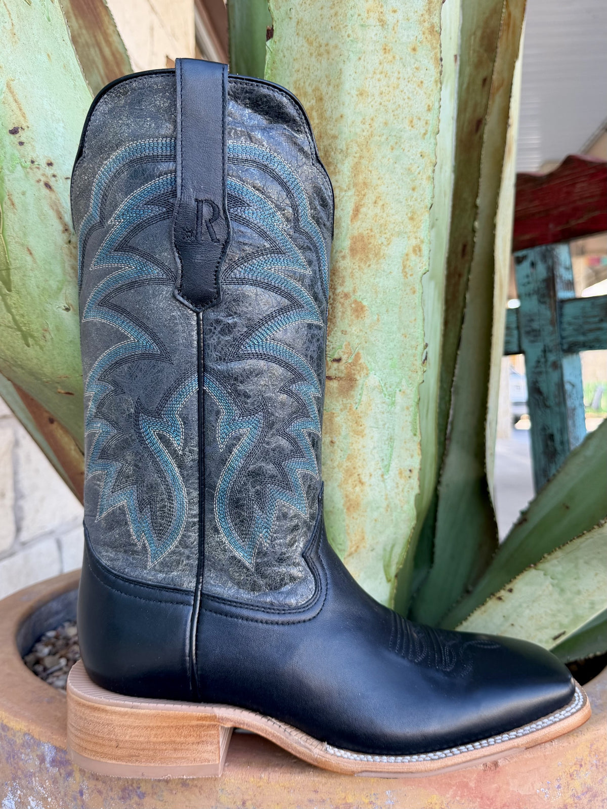 Side view of black square-toe Western boot with charcoal shaft, gray-blue stitching and natural-toned walking heel — Blair's Western Wear Marble Falls TX