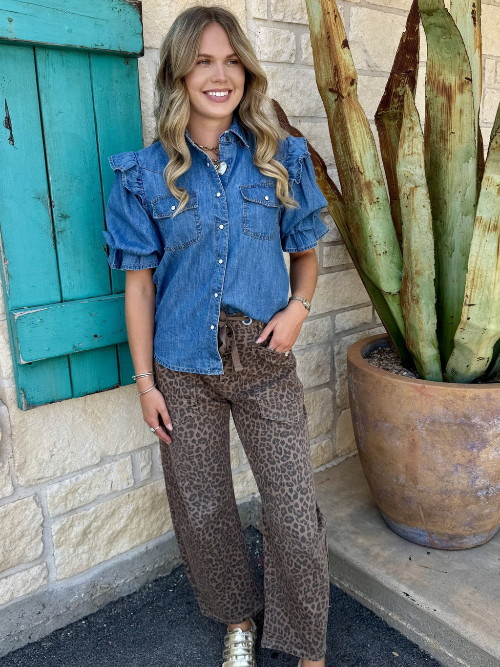 Women's brown leopard barrel crop jean styled with ruffle denim shirt and gold sneakers, full outfit front view — Blair's Western Wear Marble Falls TX