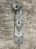 Men's light gray necktie with black bandana-inspired paisley and floral print, smooth woven finish, standard width pointed tip — Blair's Western Wear Marble Falls TX