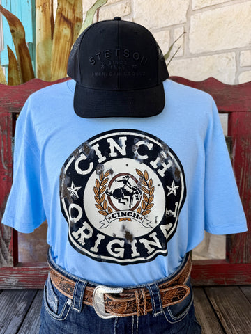 Men's light blue Cinch Original distressed bronc rider badge logo short sleeve tee, front view styled with jeans and tooled leather belt — Blair's Western Wear Marble Falls TX
