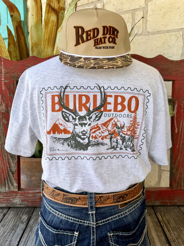 Men's heather gray Burlebo Outdoors Stamp Buck short sleeve tee with bold orange brown black vintage postage stamp buck mountain scene front graphic and BURLEBO OUTDOORS block letter text, front view styled with jeans and tooled leather belt — Blair's Western Wear Marble Falls TX