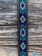 Kids Aztec Beaded Tooled Leather Belt -  XIBB101K - This kid's western belt pairs genuine hand-tooled leather with a bold Aztec-inspired beaded inlay in cobalt blue, turquoise, and white — finished with a classic engraved silver buckle. Available at Blair's Western Wear located in Marble Falls TX 