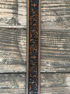 Leather Western belt featuring a hand-tooled floral pattern with a textured black background and a centered cross design. Finished with double white contrast stitching, matching leather keeper, and a polished silver roller buckle. Built for everyday wear with durable leather construction and classic Western craftsmanship.

Available at Blairs' Western Wear, located in Marble Falls.