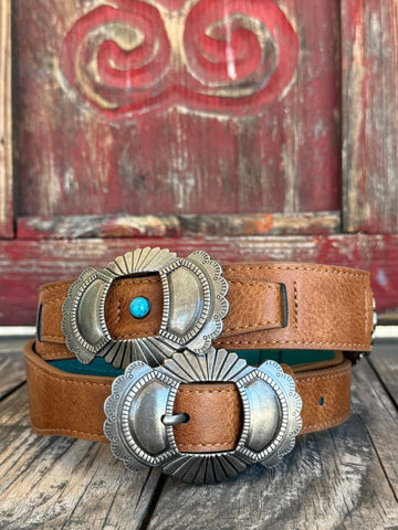 Brown leather with large silver scalloped conchos featuring a turquoise center stone — a bold, southwestern-inspired western belt with dramatic hardware and rich color that makes an instant statement.