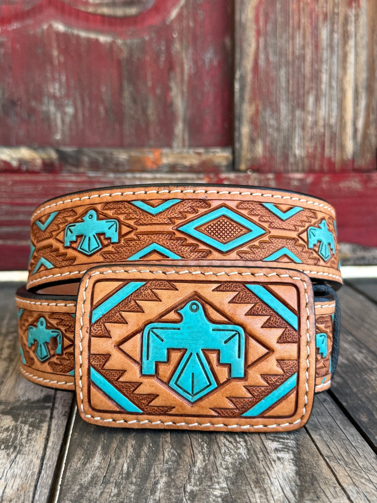 Rich tan tooled leather meets a painted turquoise Aztec-inspired bird design; — a bold, color-forward western belt with deep southwestern character that turns heads from across the room. The intricate tooling and vivid turquoise tones bring a heritage-inspired artistry to everyday western style, making this belt as much a statement piece as it is a wardrobe staple.