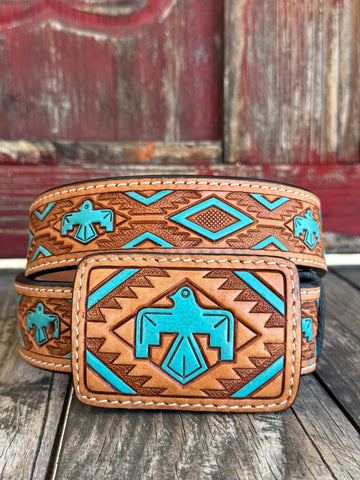 Rich tan tooled leather meets a painted turquoise Aztec-inspired bird design; — a bold, color-forward western belt with deep southwestern character that turns heads from across the room. The intricate tooling and vivid turquoise tones bring a heritage-inspired artistry to everyday western style, making this belt as much a statement piece as it is a wardrobe staple.