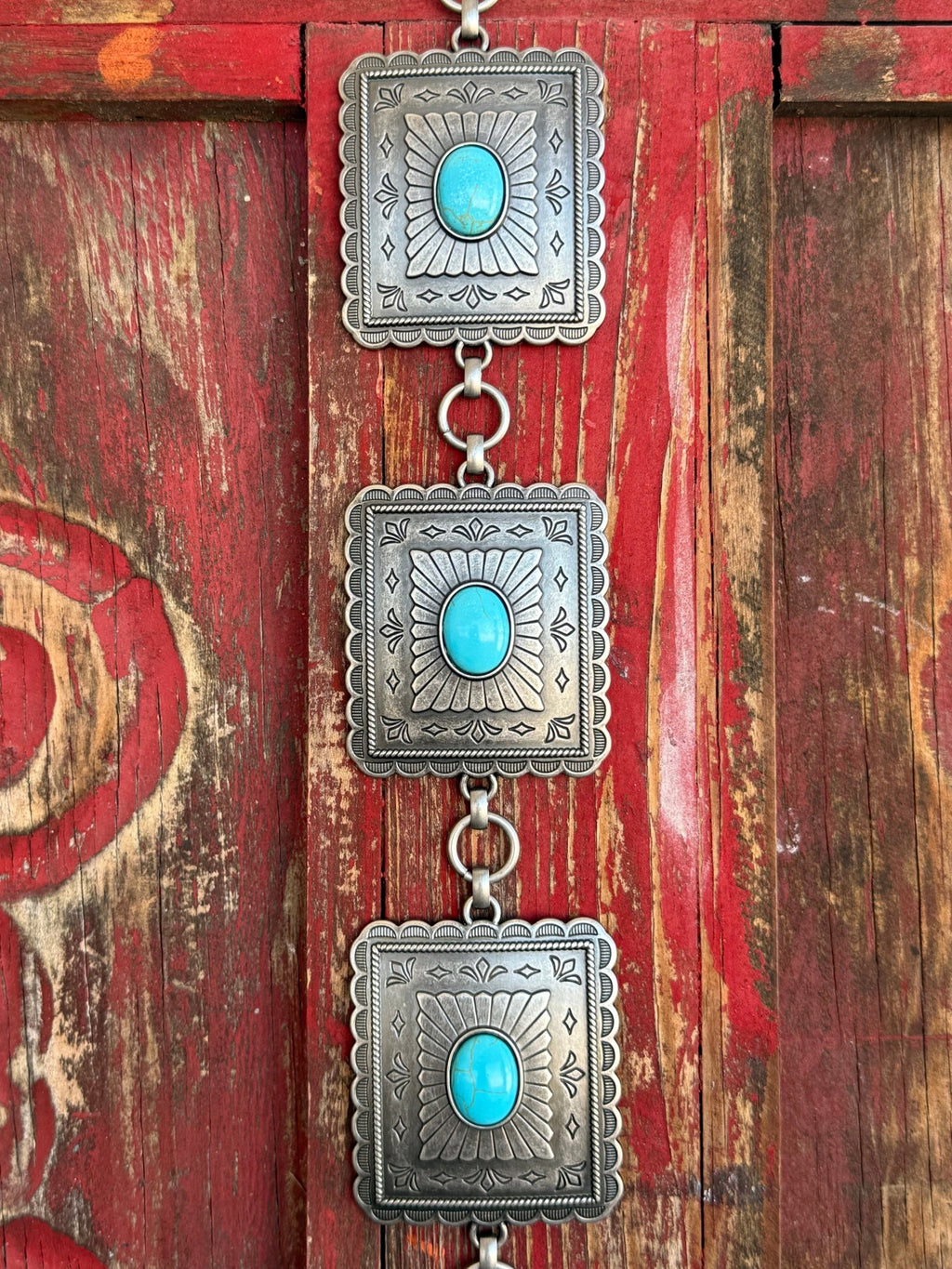 Ladies M & F Western concho belt in silver with turquoise stones, featuring scalloped square conchos and adjustable chain links for a perfect fit – A1567433. Available at Blair’s Western Wear, Marble Falls, TX.