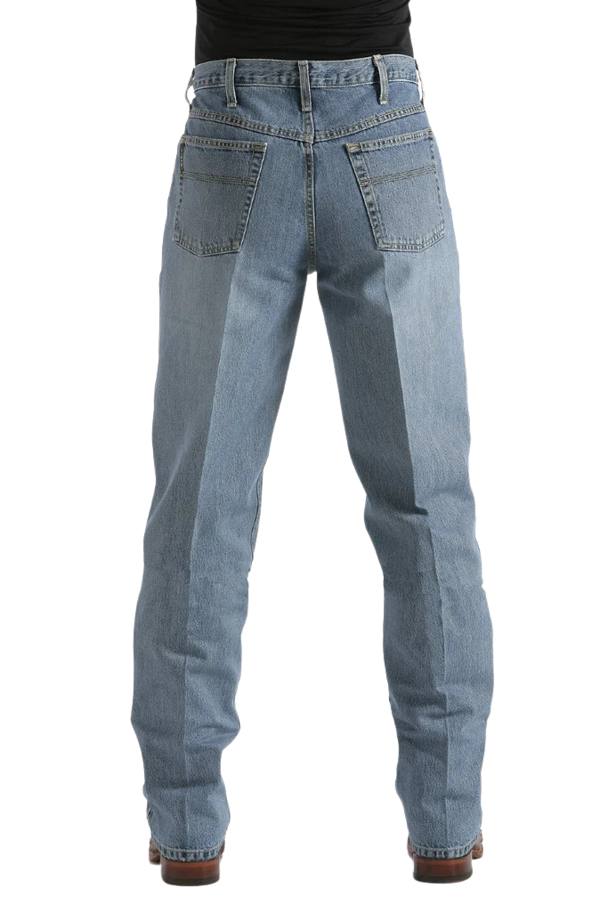 Rear view of a person wearing light blue denim jeans with a black top and brown shoes, shown against a plain white background.
